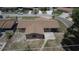 Aerial view of a home featuring a driveway, backyard patio, and partial fencing in a neighborhood setting at 6514 La Mesa Cir, Tampa, FL 33634