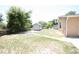Backyard featuring shed, lawn, and partial view of the home's exterior at 6514 La Mesa Cir, Tampa, FL 33634