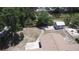 Backyard showcasing a shed and partially fenced yard, with mature trees providing shade and privacy at 6514 La Mesa Cir, Tampa, FL 33634
