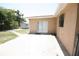 Backyard view showing the exterior of the home, shed, and patio at 6514 La Mesa Cir, Tampa, FL 33634