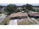 Single-story home with a covered entrance and driveway, complemented by a shed in the backyard and neighborhood view at 6514 La Mesa Cir, Tampa, FL 33634