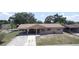 Aerial exterior shot of the home with carport and covered front porch at 6514 La Mesa Cir, Tampa, FL 33634
