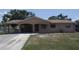 Exterior shot of home with carport and covered front porch at 6514 La Mesa Cir, Tampa, FL 33634