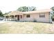 Beige single-story home features a covered carport and a simple, tidy lawn at 6514 La Mesa Cir, Tampa, FL 33634