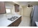 Functional kitchen boasts light countertops, dark wood cabinets, and open access to the living room at 6514 La Mesa Cir, Tampa, FL 33634