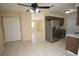 Bright kitchen with stainless steel refrigerator and neutral tile flooring for easy cleaning at 6514 La Mesa Cir, Tampa, FL 33634