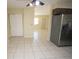 Bright kitchen with stainless steel refrigerator and neutral tile flooring for easy cleaning at 6514 La Mesa Cir, Tampa, FL 33634