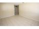 Spacious living room boasts neutral walls, tile flooring, and a ceiling fan visible through an opening at 6514 La Mesa Cir, Tampa, FL 33634