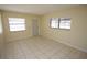 Sunlit living room offers tiled floors, neutral walls, and multiple windows at 6514 La Mesa Cir, Tampa, FL 33634