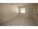Bright living room features tile floors, neutral walls, and a window for natural light at 6514 La Mesa Cir, Tampa, FL 33634