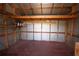 Shed interior view shows the exposed beams and shelving at 6514 La Mesa Cir, Tampa, FL 33634