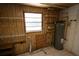 Utility room with window, shelving and water heater at 6514 La Mesa Cir, Tampa, FL 33634