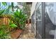 Lush backyard area with tropical plants, wood fencing, and a stone path along the side of the house at 775 N Village N Dr # 106, St Petersburg, FL 33716
