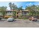Inviting two-story condo with tropical landscaping, reserved parking, and a charming fence for added curb appeal at 775 N Village N Dr # 106, St Petersburg, FL 33716