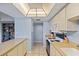 Updated kitchen features bright lighting, updated appliances, white cabinets and a view of the living area at 775 N Village N Dr # 106, St Petersburg, FL 33716