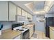 Well-lit kitchen featuring essential appliances, white cabinetry and a view to the yard, ready for cooking at 775 N Village N Dr # 106, St Petersburg, FL 33716