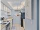 Efficient kitchen with white cabinets, essential appliances, and bright lighting, great for everyday meal preparation at 775 N Village N Dr # 106, St Petersburg, FL 33716