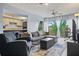 Cozy living room with modern furnishings, ample seating, and sliding glass doors that bring in natural light at 775 N Village N Dr # 106, St Petersburg, FL 33716