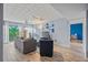Bright living room with wood floors, comfortable seating, stylish decor, and sliding glass doors at 775 N Village N Dr # 106, St Petersburg, FL 33716