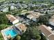 Community aerial view featuring rooftops, trees, parking lots and a community pool at 776 116Th N Ave # 1110, St Petersburg, FL 33716