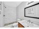 Bathroom featuring a marble-tiled shower, updated vanity, and modern fixtures at 776 116Th N Ave # 1110, St Petersburg, FL 33716