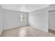 Bedroom featuring neutral tile floors, a window, and an adjacent closet at 776 116Th N Ave # 1110, St Petersburg, FL 33716