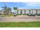 Condominium exterior featuring tropical landscaping, palm trees, ample parking, and a well-maintained façade at 776 116Th N Ave # 1110, St Petersburg, FL 33716