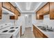 Efficient kitchen with white appliances, wood cabinetry, and marble countertops at 776 116Th N Ave # 1110, St Petersburg, FL 33716