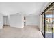 Bright living room featuring tiled floors, ceiling fan, and sliding glass doors leading to outdoor balcony at 776 116Th N Ave # 1110, St Petersburg, FL 33716