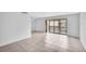 Bright living room featuring neutral tile floors and sliding glass doors to the balcony at 776 116Th N Ave # 1110, St Petersburg, FL 33716
