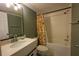 Bathroom featuring a white vanity, framed mirror, and bathtub with tiled walls and shower at 800 Cove Cay Dr # 4F, Clearwater, FL 33760