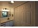 Bathroom featuring a vanity with modern fixtures and a large closet with bi-fold doors at 800 Cove Cay Dr # 4F, Clearwater, FL 33760