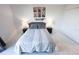 Cozy bedroom with gray accents, modern lamps, and unique wall decorations above the bed at 800 Cove Cay Dr # 4F, Clearwater, FL 33760