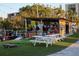 Outdoor recreation area with a bar, picnic tables, and lawn games for community entertainment at 800 Cove Cay Dr # 4F, Clearwater, FL 33760