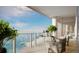 Oceanfront balcony featuring comfortable chairs, table, and railing at 805 S Gulfview Blvd # 506A, Clearwater, FL 33767