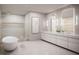 Modern bathroom featuring a soaking tub, double sinks, and glass shower at 805 S Gulfview Blvd # 506A, Clearwater, FL 33767