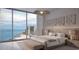 Bedroom featuring views of the water, a padded headboard, and comfortable seating at 805 S Gulfview Blvd # 506A, Clearwater, FL 33767