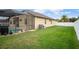 A beautifully landscaped backyard with a pool, grassy area, and privacy fence at 8511 White Poplar Dr, Riverview, FL 33578