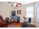Bedroom with a pinball machine, ceiling fan, window, and wood floors at 8511 White Poplar Dr, Riverview, FL 33578
