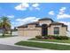 Inviting home with lush landscaping, well-kept lawn, and a convenient three-car garage at 8511 White Poplar Dr, Riverview, FL 33578