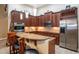 Modern kitchen with stainless steel appliances, a granite countertop, breakfast bar, and pendant lighting at 8511 White Poplar Dr, Riverview, FL 33578