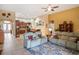 Spacious living room with comfortable seating, an attractive rug, and easy access to the kitchen and dining areas at 8511 White Poplar Dr, Riverview, FL 33578