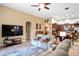 Inviting living room with plush seating, tile flooring, and an open layout to the kitchen and dining areas at 8511 White Poplar Dr, Riverview, FL 33578