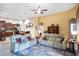 Bright and airy living room featuring comfortable sofas, a ceiling fan, and an open design for easy entertaining at 8511 White Poplar Dr, Riverview, FL 33578