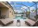 Beautiful screened-in pool area with lounge chairs, creating a relaxing outdoor oasis at 8511 White Poplar Dr, Riverview, FL 33578
