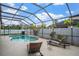 A screened-in pool area with comfortable lounge seating and a well-maintained fence for privacy at 8511 White Poplar Dr, Riverview, FL 33578