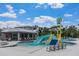 Splash zone with slide at resort-style community pool with lounge seating and clubhouse view at 8511 White Poplar Dr, Riverview, FL 33578