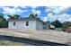 New home showing the side and front on a large lot with a partially obscured two-car garage at 9149 Willmington Blvd, Englewood, FL 34224