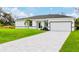 Beautiful home featuring a spacious driveway, two-car garage, and well-manicured lawn at 9149 Willmington Blvd, Englewood, FL 34224