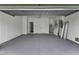 Spacious garage with a painted floor, featuring ample room for parking and storage at 9149 Willmington Blvd, Englewood, FL 34224